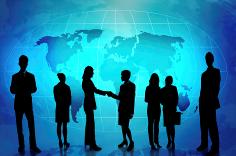 Group of business people standing in front of an illuminated world map.