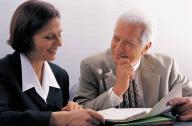 Two business people looking over a document together.