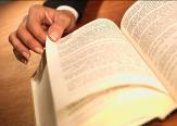 Hand paging through a book.